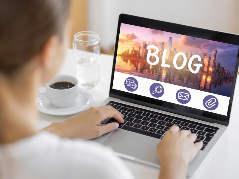 Person blogging on a laptop at desk.