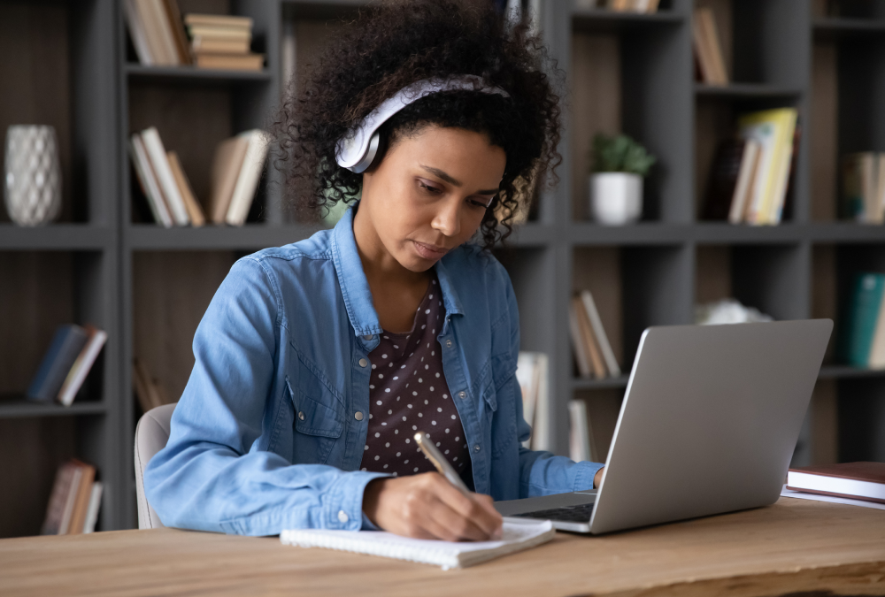 Person studying with laptop and headphones.